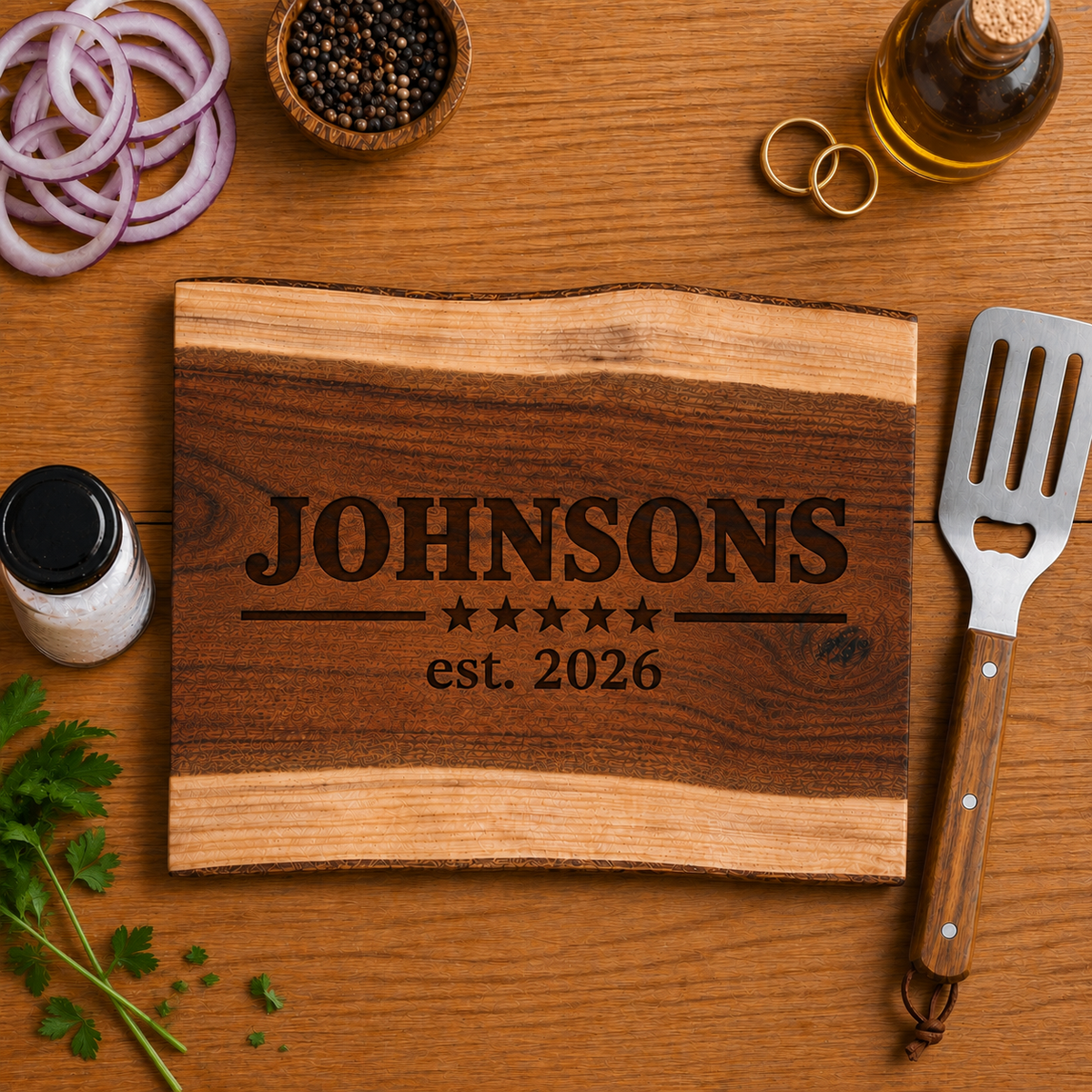 Personalized wood cutting board engraved with “Johnsons” and “est. 2026,” styled with wedding rings as a custom wedding or anniversary gift.