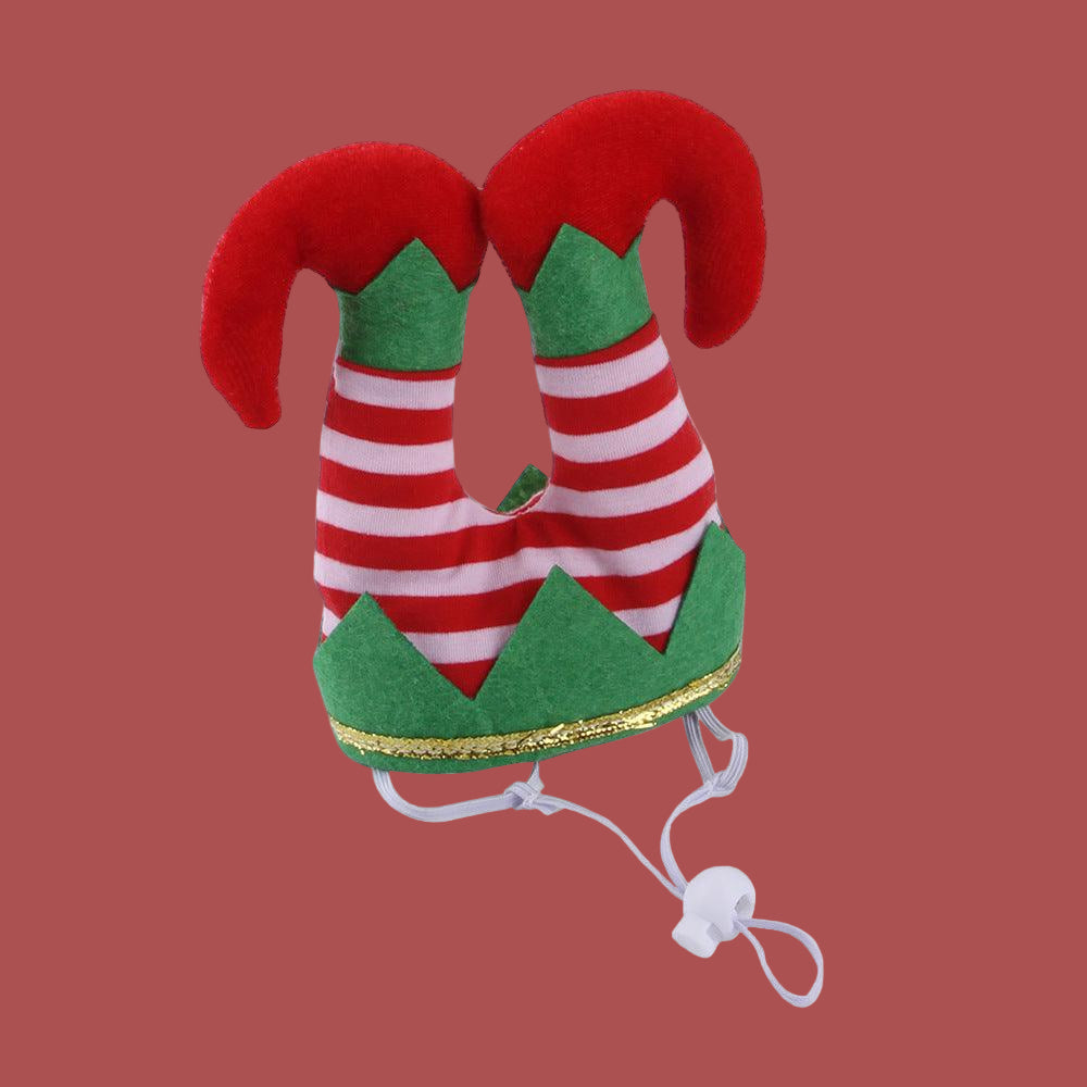 Close-up of red and green striped pet Christmas hat with elastic strap