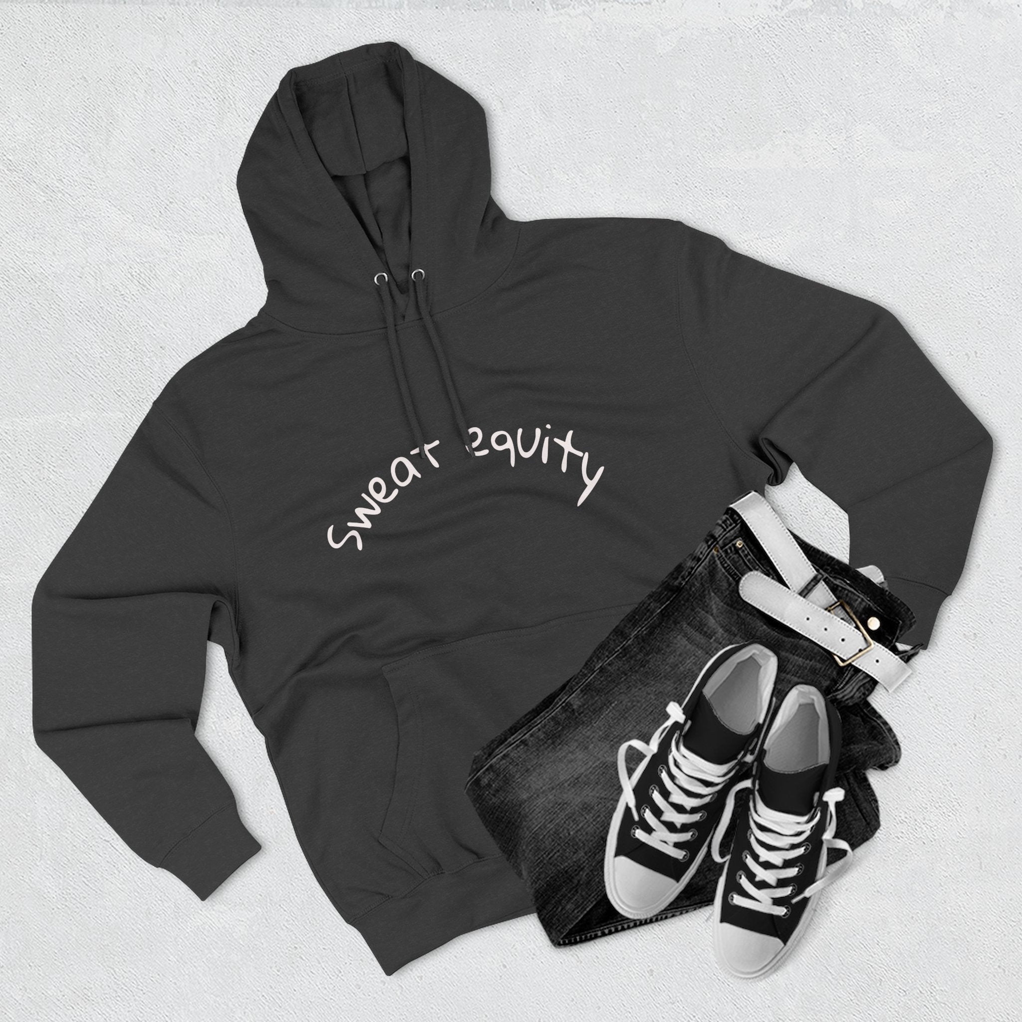 Black “Sweat Equity” hoodie displayed flat with black jeans, belt, and sneakers, modern unisex fitness and motivation sweatshirt for gym lovers and entrepreneurs.