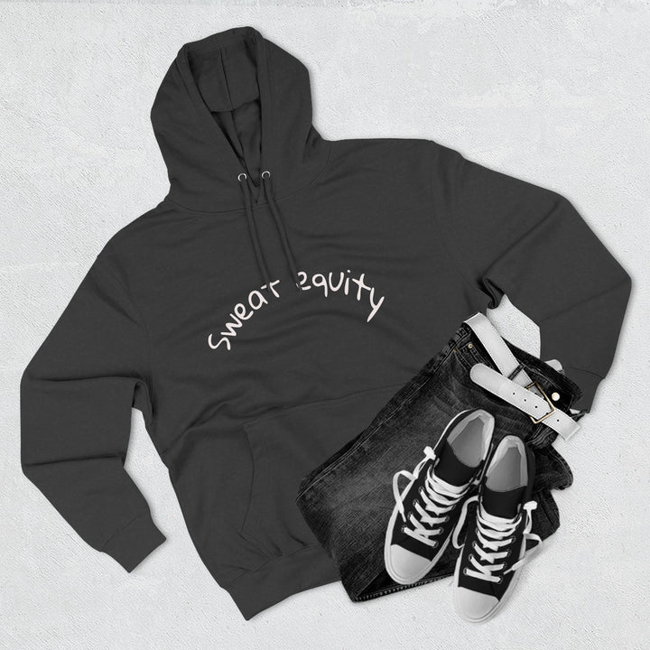 Black “Sweat Equity” hoodie displayed flat with black jeans, belt, and sneakers, modern unisex fitness and motivation sweatshirt for gym lovers and entrepreneurs.