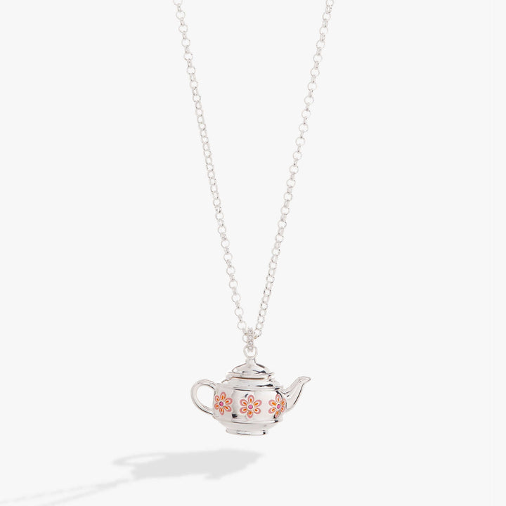 Silver teapot-shaped pendant on a chain against a white background