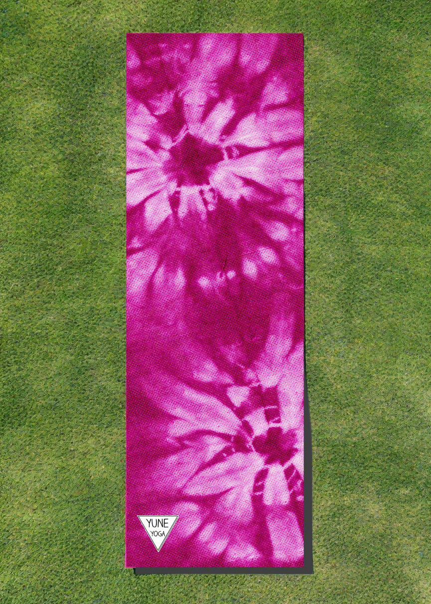Pink tie-dye yoga mat with a visible brand logo on a white background