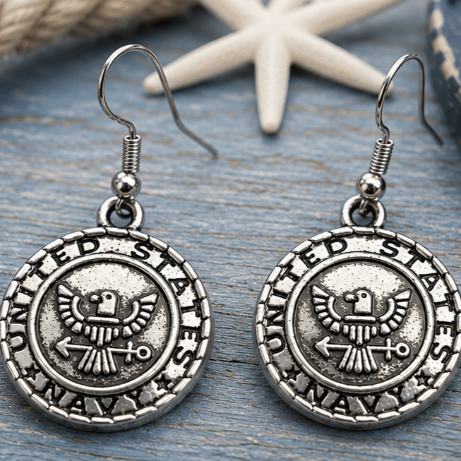 Silver-tone United States Navy patriotic dangle earrings displayed on a nautical-themed background with rope and starfish accent.